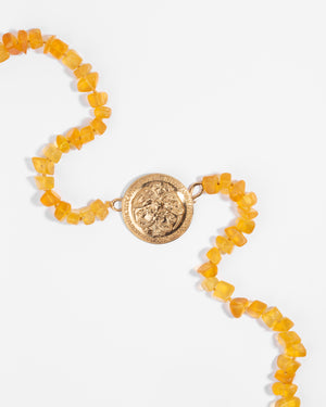 Serpentine brooch with raw amber necklace