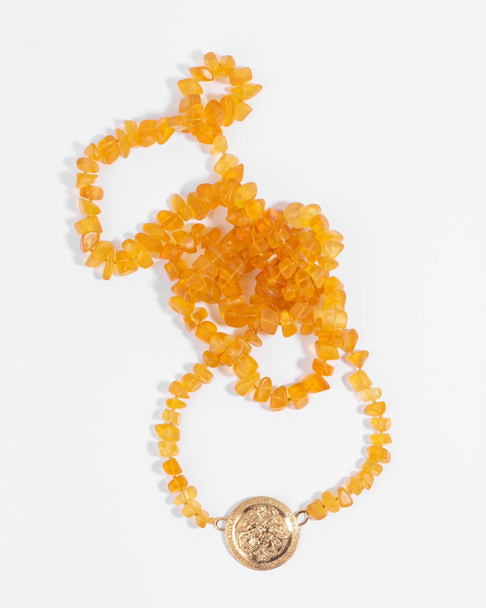 Serpentine brooch with raw amber necklace