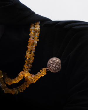 Serpentine brooch with raw amber necklace