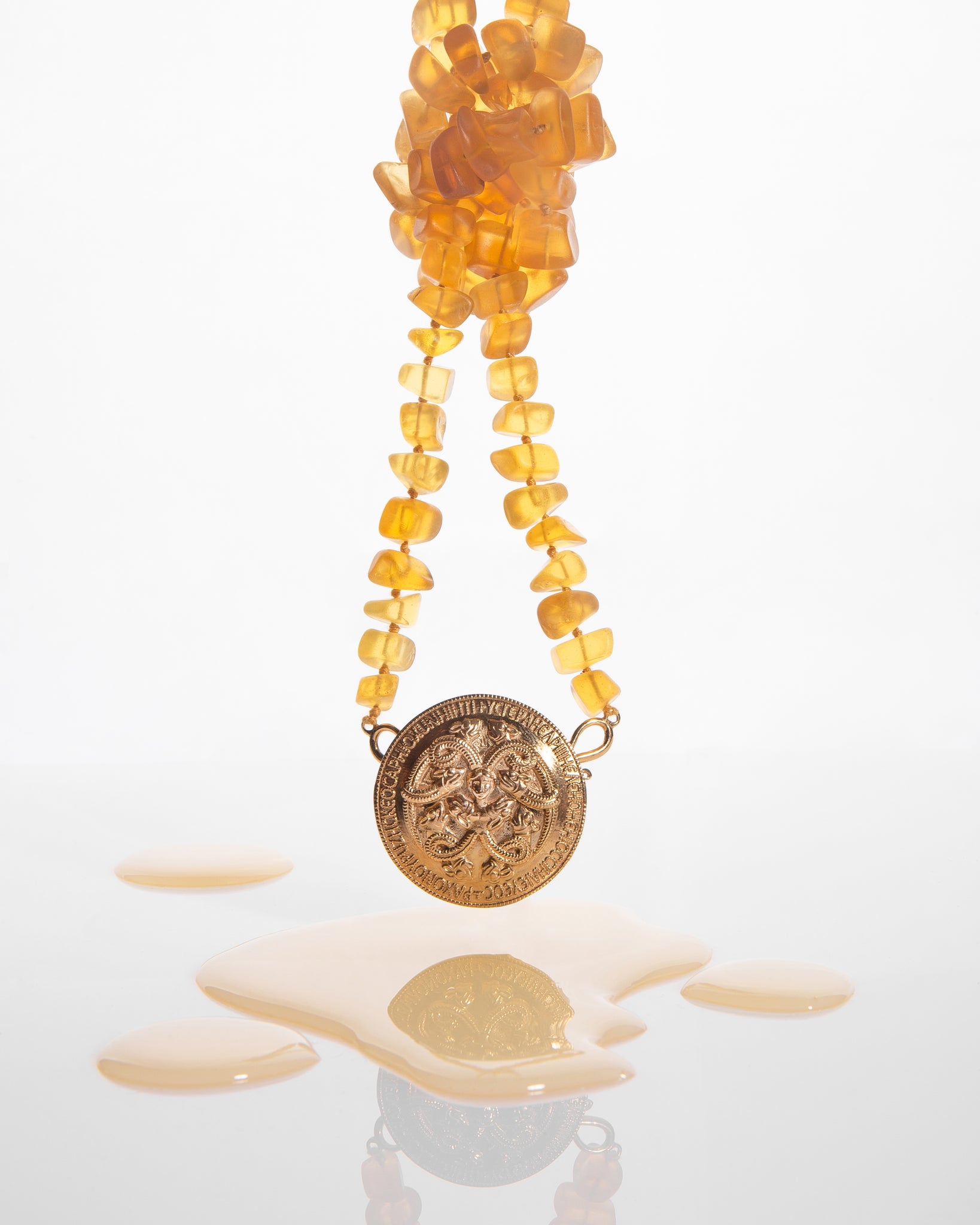 Serpentine brooch with raw amber necklace