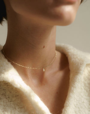 Gold choker with a charm