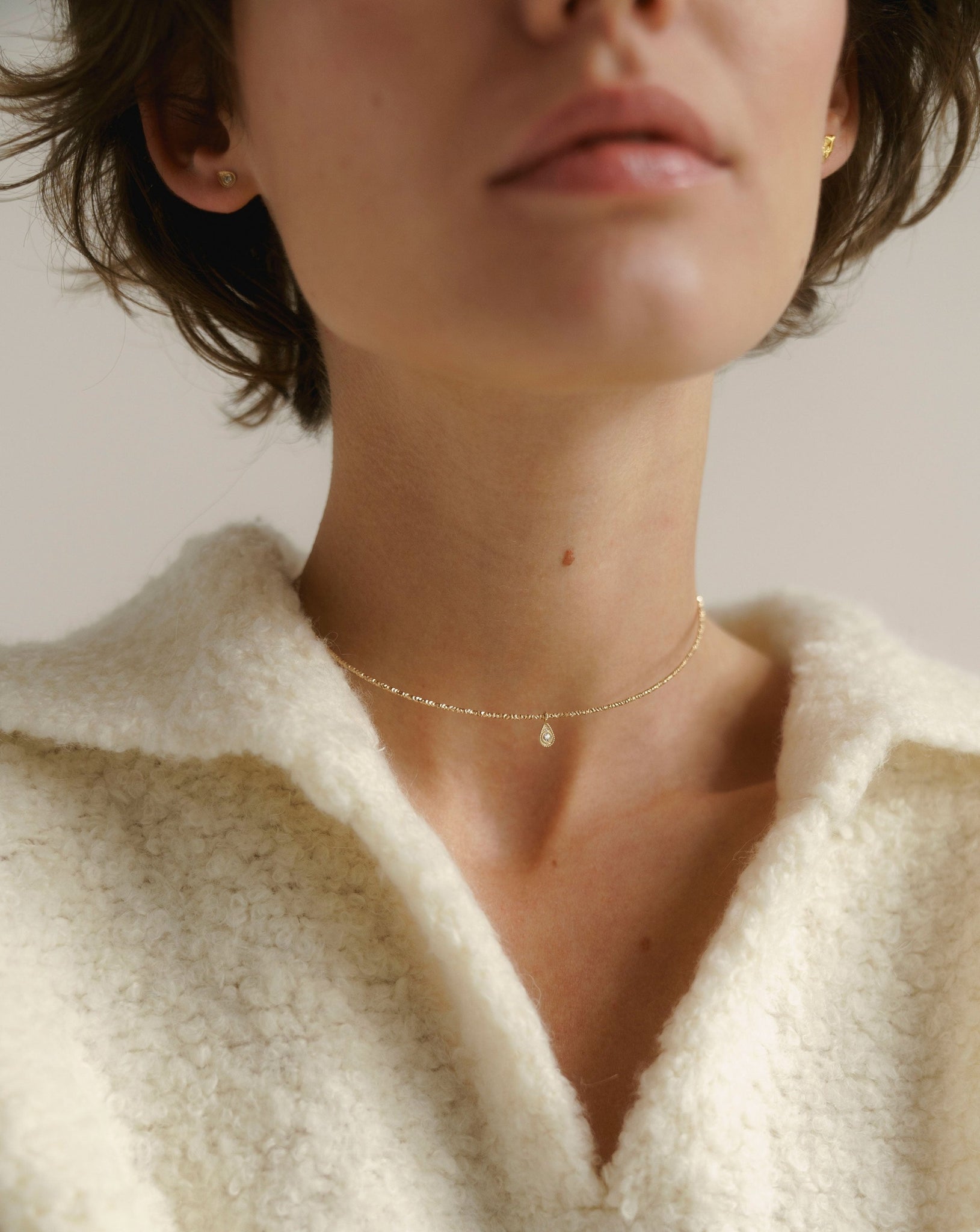 Gold choker with a charm